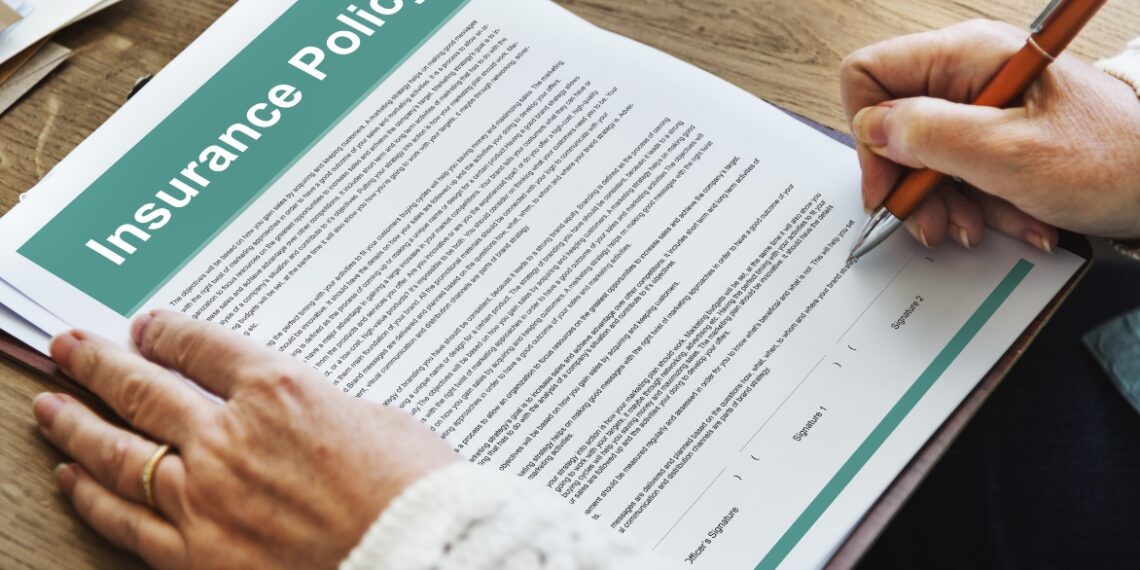 Man signing insurance policy contract