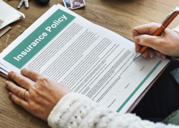 Man signing insurance policy contract