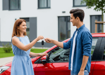 Two people exchanging car keys