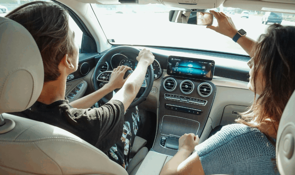Interior view of two people sitting in a car